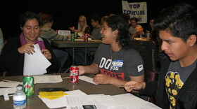 (Left to right) Rancho Buena Vista High School seniors Sefath Khan, Jazmin Zamora, and Josue Luna take part in the Amnesty International letter-writing campaign  at the high school Dec 7, 2014