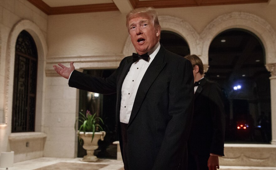 President Donald Trump speaks with reporters as he arrives for a New Year's Eve gala at his Mar-a-Lago resort, in Palm Beach, Fla., on Sunday.