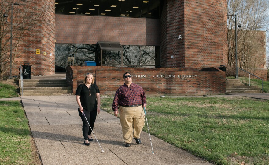 Miranda Lacy and Harold Rogers walk around the campus of West Virginia State University, where both completed undergraduate degrees. They consider the campus a second home because staff there worked hard to make sure their education was accessible. Now, they're in a graduate program that they say has failed to make their learning materials accessible and have filed a lawsuit.