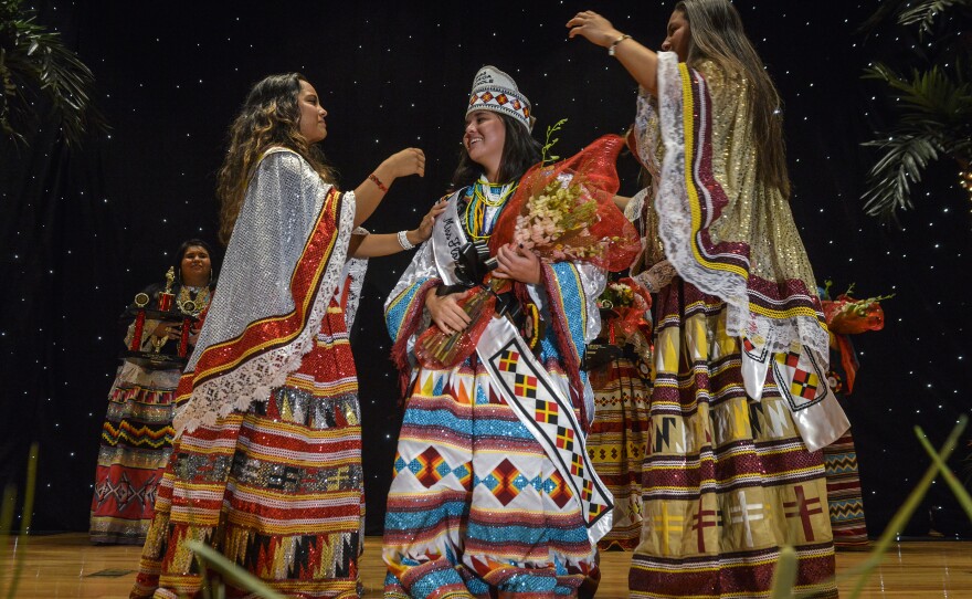 Last year's royalty, Cheyenne Nunez (left) and Brianna Nunez (right) flank Destiny Nunez (Brianna's sister and Cheyenne's cousin) as she is declared the winner of the Miss Florida Seminole Princess Pageant on July, 25, 2015 in Hollywood, Fla.