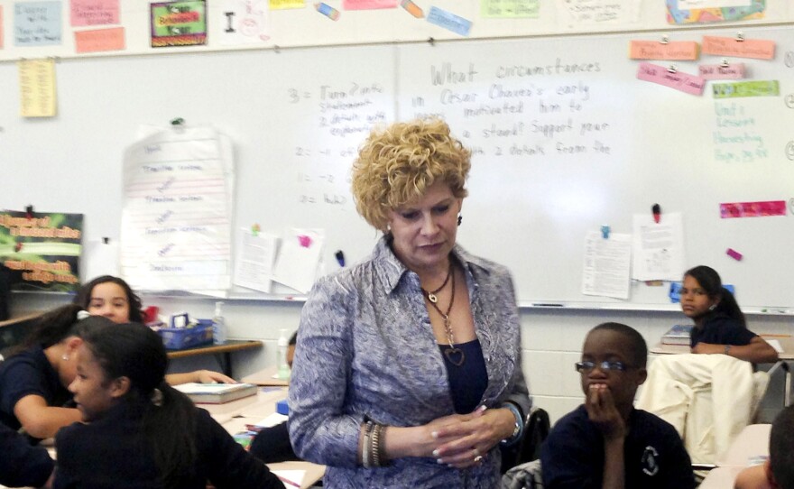 Julia de Burgos Elementary teacher Gail Kantor, shown here in her sixth-grade class, says she buys things like clothing, books and school supplies for her students with her own money. "Some kids don't ever have a dime," she says.