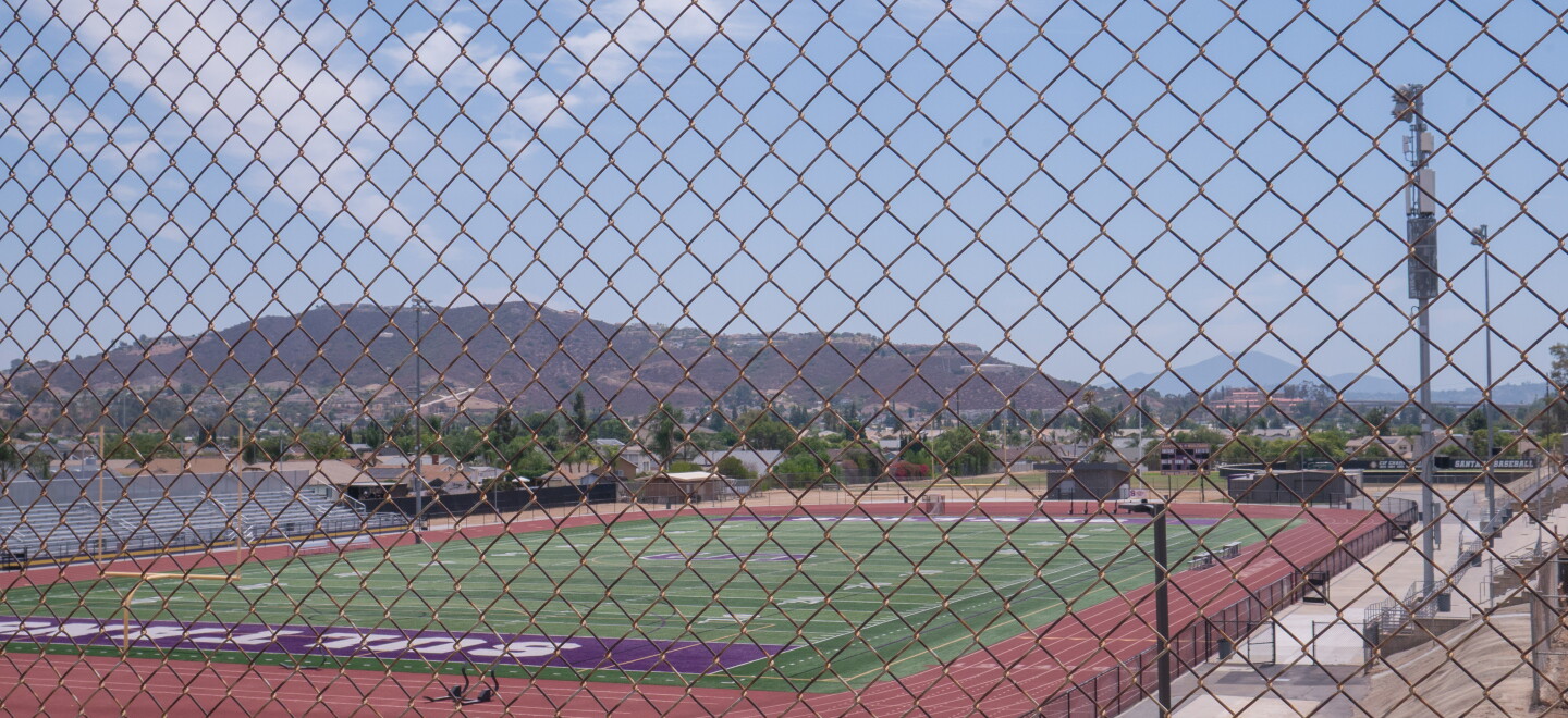 Santana High School's football field, on the east side of campus, is shown through a chain link fence on Aug. 12, 2026.
