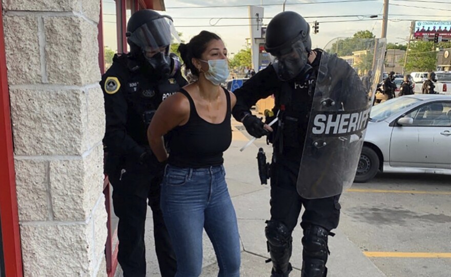 Police officers are shown arresting Des Moines Register reporter Andrea Sahouri after a Black Lives Matter protest she was covering on May 31, 2020, in Des Moines, Iowa. Sahouri went on trial Monday on charges of failing to disperse and interfering with official acts.