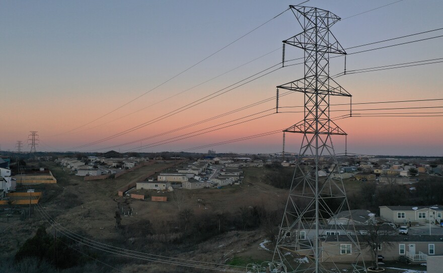 "As Texans struggled to survive this winter storm, Griddy made the suffering even worse as it debited outrageous amounts each day," Texas Attorney General Ken Paxton said as his office sued the company. Here, electrical lines run through a neighborhood in Austin during the recent winter storms.