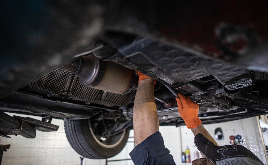 Mechanic Alex Esparza works on a vehicle at Van Ness Auto Repair in Fresno, on Sept. 13, 2022.