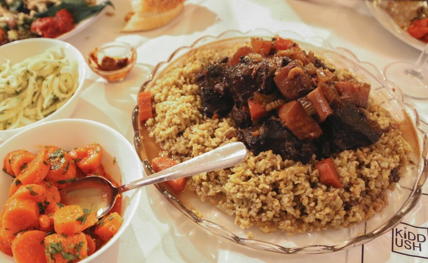 Moroccan-Israeli dishes and challah are served at a Jewish Sabbath pop-up dinner party hosted at a Berlin bookstore, part of the festivities surrounding Nosh Berlin, the city's first Jewish food festival.