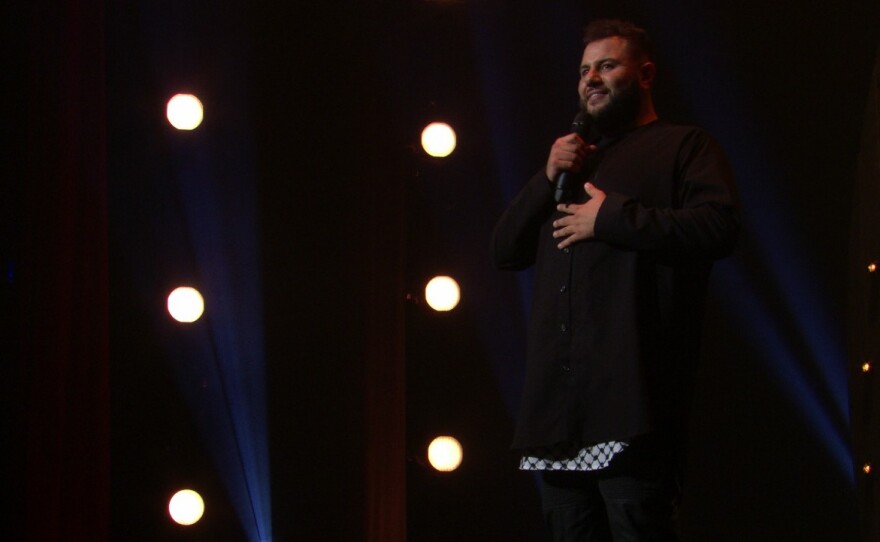 Comedian Mo Amer, seen here in his Netflix special <em>The Vagabond</em>, says that stand-up has been a significant part of his "coping process" with an itinerant childhood.