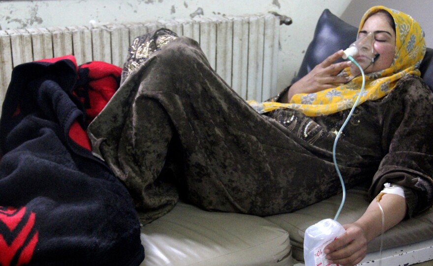 A woman, affected by what activists say was a chlorine gas attack, breathes through an oxygen mask inside a field hospital in Kfar Zeita village in the central province of Hama on April 12. Activists, doctors and political opposition members say there have been at least seven gas attacks in the past six weeks.