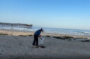 Vi Nguyen picks up trash on Pacific Beach in this undated photo. Nguyen is a local pediatrician who has been picking up plastic along San Diego's coastline for the past seven years.