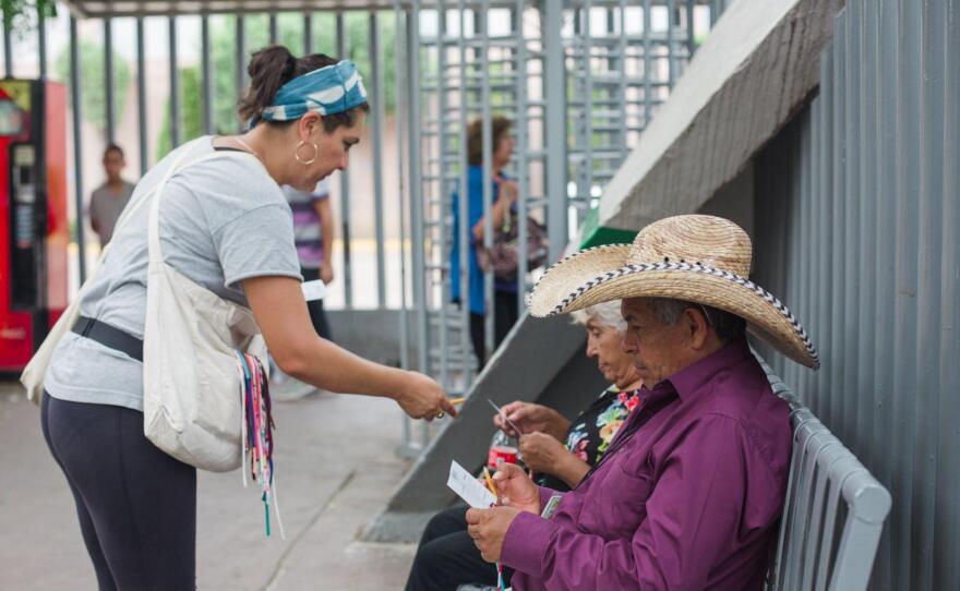 Artist Tanya Aguiñiga asking people who cross the U.S.-Mexico border communities to participate in the making of her art project <em>Border Quipu</em>.