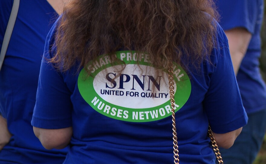 A nurse wearing a t-shirt with the Sharp Professional Nurses Network on it is shown at a rally outside Sharp Headquarters in Kearny Mesa on September 17, 2025.