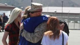 Petty Officer 1st Class Nathan Hardin, an independent duty corpsman serving with 2nd Battalion, 5th Marine Regiment, reunites with his family