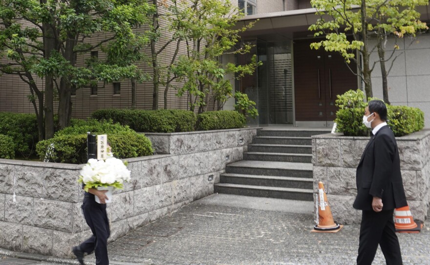 Flowers arrive at the residence of former Prime Minister Shinzo Abe in Tokyo Thursday, Aug. 25, 2022. Abe's family paid tribute to him in a private ritual Buddhist ritual Thursday marking the 49th day of his assassination.