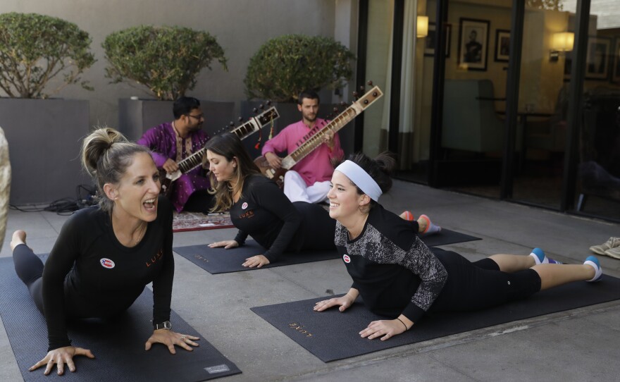 Yoga instructor Rachel Jackson (left) leads a free yoga session for voters outside a polling place at Luxe Sunset Boulevard Hotel in Los Angeles on Tuesday.