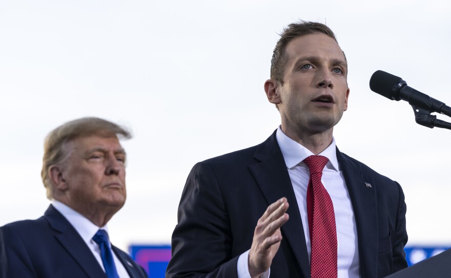 Former President Donald Trump listens as Max Miller, Republican nominee for Ohio's 7th Congressional District, speaks during a rally on April 23 in Delaware, Ohio.