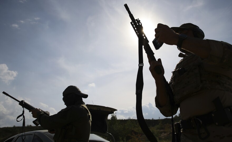 Volunteers from Belarus practice at a shooting range near Warsaw, Poland, on May 20. Belarusians are among those who have answered a call by Ukrainian President Volodymyr Zelenskyy for foreign fighters to go to Ukraine and join the International Legion for the Territorial Defense of Ukraine.