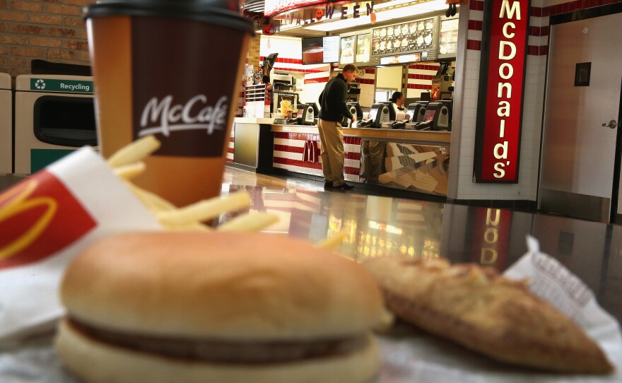 Customers order food from a McDonald's restaurant in Des Plaines, Ill. The company has promised to start buying "verified sustainable beef" in 2016.