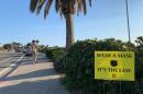 A sign advising visitors to wear a facial covering in Del Mar, Calif. Aug. 14, 2020.