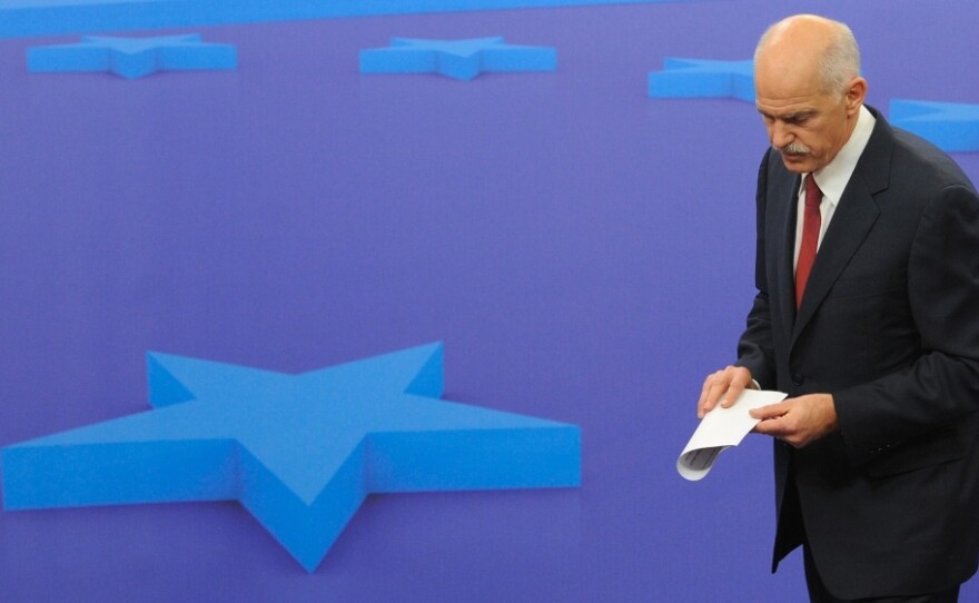 <p>Greek Prime Minister George Papandreou leaves a news conference after a meeting with European Council President Herman Van Rompuy on Oct. 13 at EU headquarters in Brussels. EU leaders were surprised and angered Tuesday when Papandreou said he would place a debt restructuring proposal before Greek voters.</p>