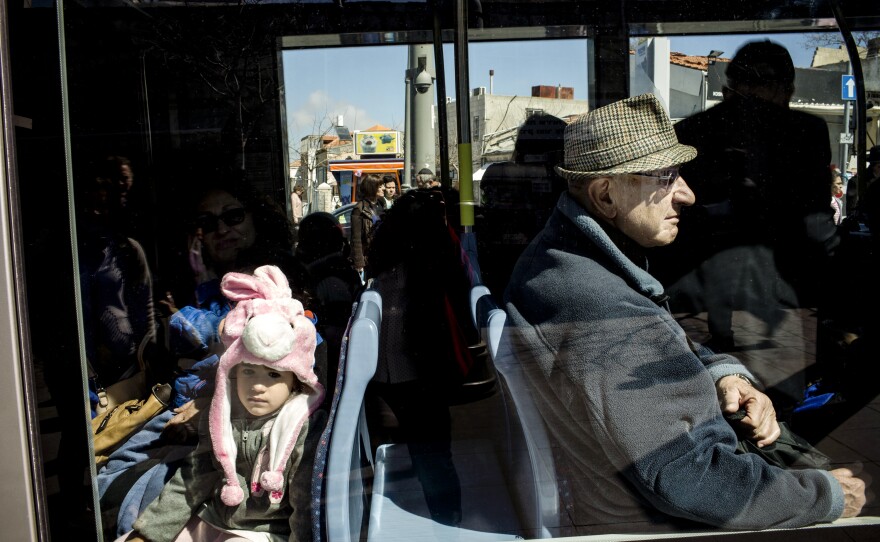 Riding on the rail line, Israeli children and adults alike are dressed for the Jewish holiday of Purim.