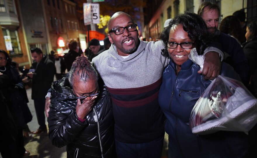 Andrew Stewart (center) walks with his mother and sister on Monday after he and two other black men were exonerated in a 1983 murder for which they were sentenced to life in prison.