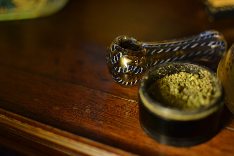 A pipe sits next a grinder full of ground marijuana, Dec. 9, 2019. 
