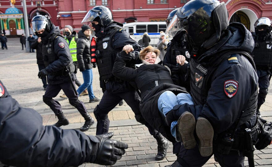 Police officers detain a woman during a protest against Russian military action in Ukraine, in Manezhnaya Square in central Moscow on March 13.