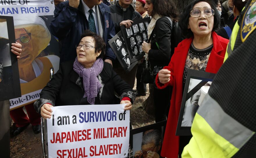 FILE - Lee Yong-soo, a South Korean sexual slavery survivor who has been demanding since the early 1990s that the Japanese government fully accept culpability and offer an unequivocal apology, participates in a protest outside the John F. Kennedy School of Government in Cambridge, Mass., where Japanese then-Prime Minister Shinzo Abe spoke on April 27, 2015.