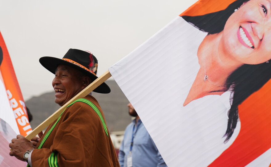 A supporters hols a banner of presidential candidate Keiko Fujimori during her closing campaign rally in Lima, Peru, Thursday.