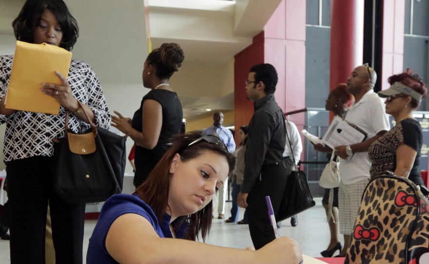 Jessica Pimentel fills out an application during a job fair in Sunrise, Fla. The latest employment numbers indicate a slowdown in job growth, but many economists are skeptical that the economy is weakening.