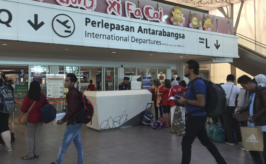 Passengers leave the departure hall Thursday at Kuala Lumpur International Airport in Malaysia where Kim Jong Nam was reportedly attacked and killed two days before.