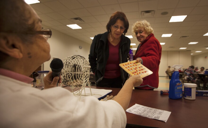 Bingo caller Zinnia Rosado of St. Cloud, Fla., checks a winning bingo card at the Robert Guevara Community Center.