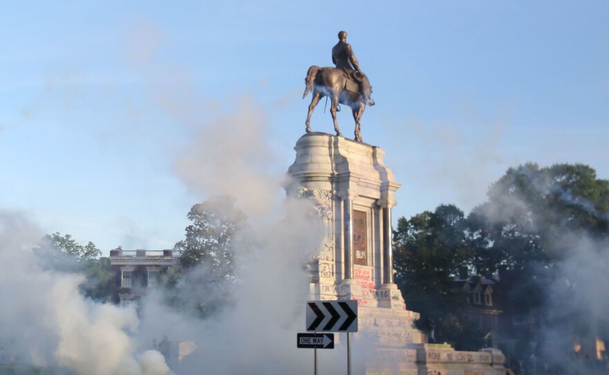 Tear gas clouds the air around the Monument Avenue statue of Confederate Gen. Robert. E. Lee on June 1, when Richmond police scattered hundreds of peaceful protesters by releasing tear gas and shooting pepper spray about 30 minutes before the 8 p.m. curfew was to go into effect.