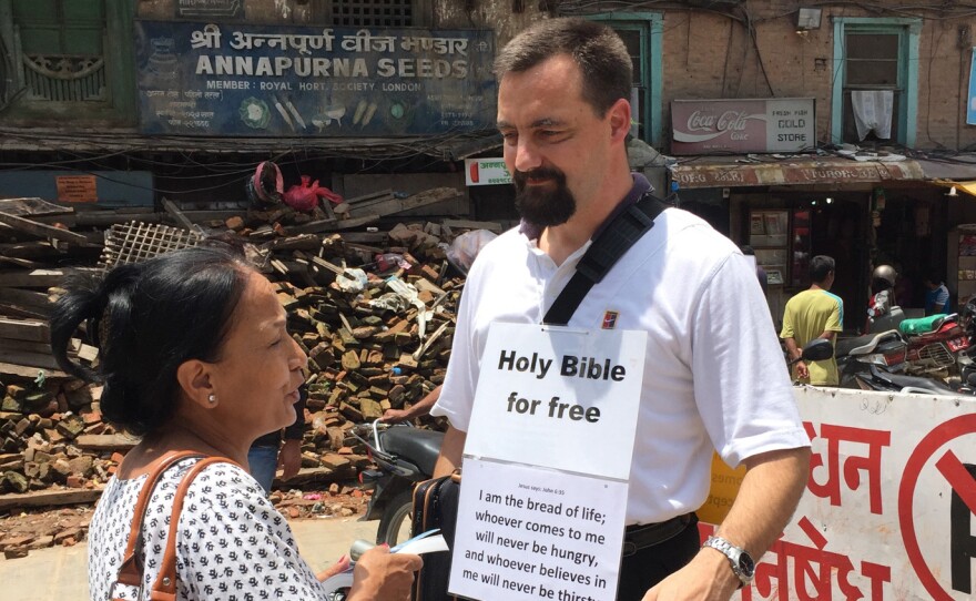 A Swiss missionary talks to a Nepali woman about the Bible in Kathmandu's old city.
