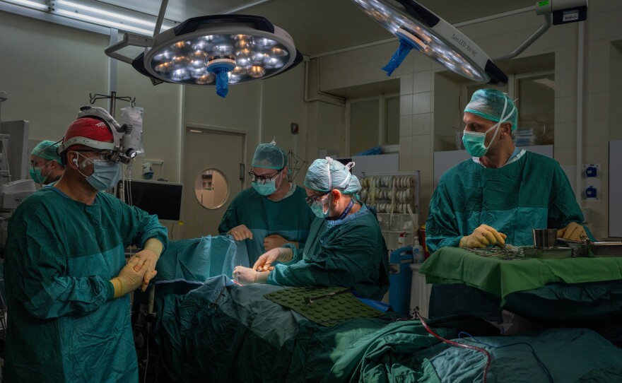 Dr. Galit Sivak (center), head of the vascular surgery department, performs surgery at Rabin Medical Center in Petah Tikvah, Israel. She has developed a surgical procedure during the Gaza war that saved the limbs of 35 severely wounded Israeli soldiers.