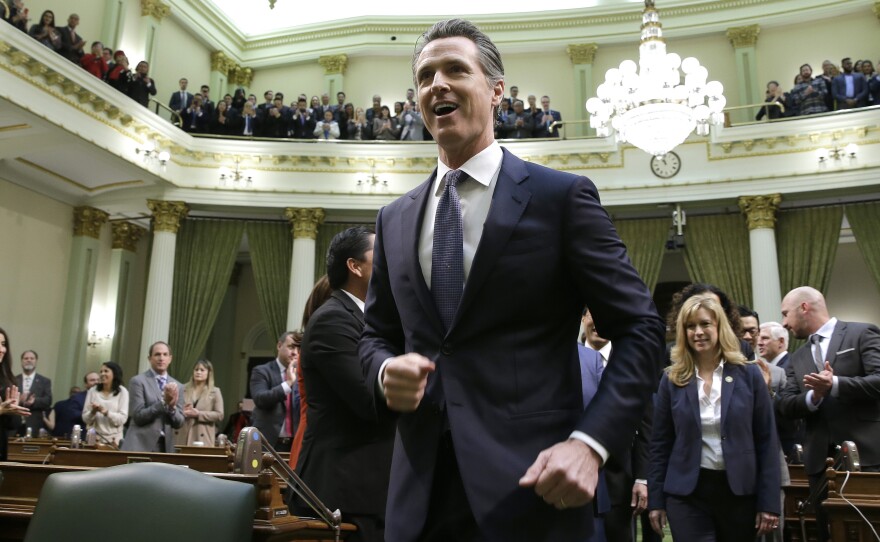 California Gov. Gavin Newsom walks up up the center aisle of the Assembly chambers to deliver his first of the State of the State in Sacramento, Calif., Feb. 12, 2019.