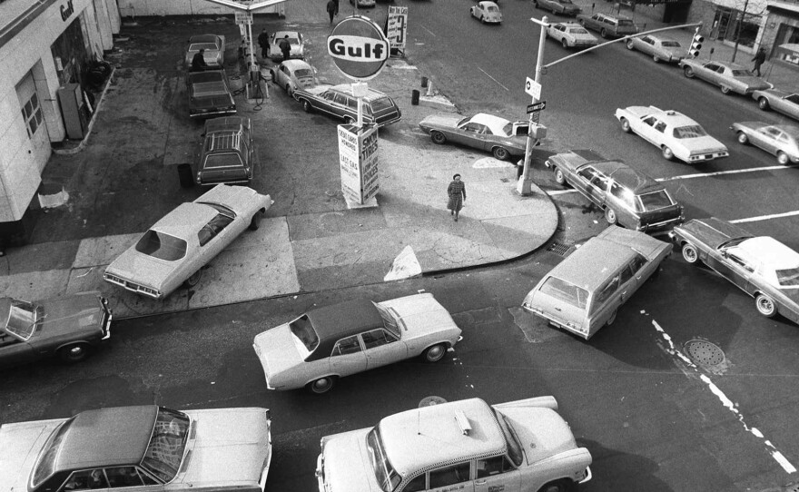 In this Dec. 23, 1973 file photo, cars line up in two directions at a gas station in New York City.