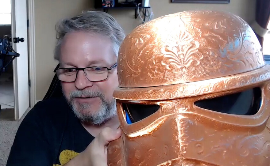 "Star Wars" fan Mark Tuttle shows off a gold Stormtrooper helmet he made.