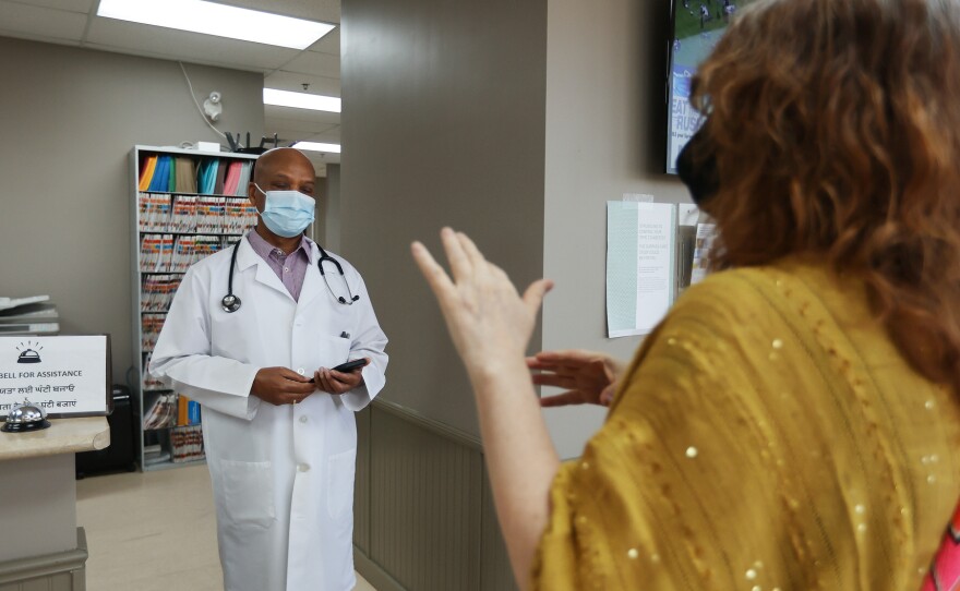 Dr. Naresh Aggarwal talks in April with Jennifer Bain, who volunteered for a study of Medicago's COVID-19 vaccine in Toronto.