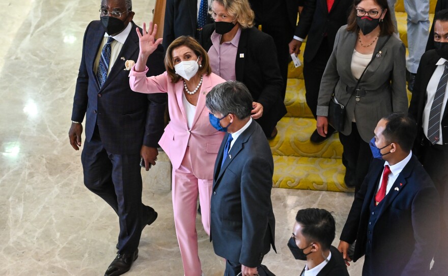 This photo from Malaysia's Department of Information, U.S. House Speaker Nancy Pelosi, center, waves to media as she tours the parliament house in Kuala Lumpur, Tuesday, Aug. 2, 2022.