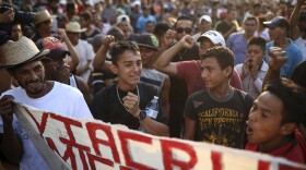 Central American migrants traveling with the annual Stations of the Cross caravan march for migrants' rights and protest the policies of U.S. President Donald Trump and Honduran President Juan Orlando Hernandez, in Matias Romero, Oaxaca State, Mexico, Tuesday, April 3, 2018.