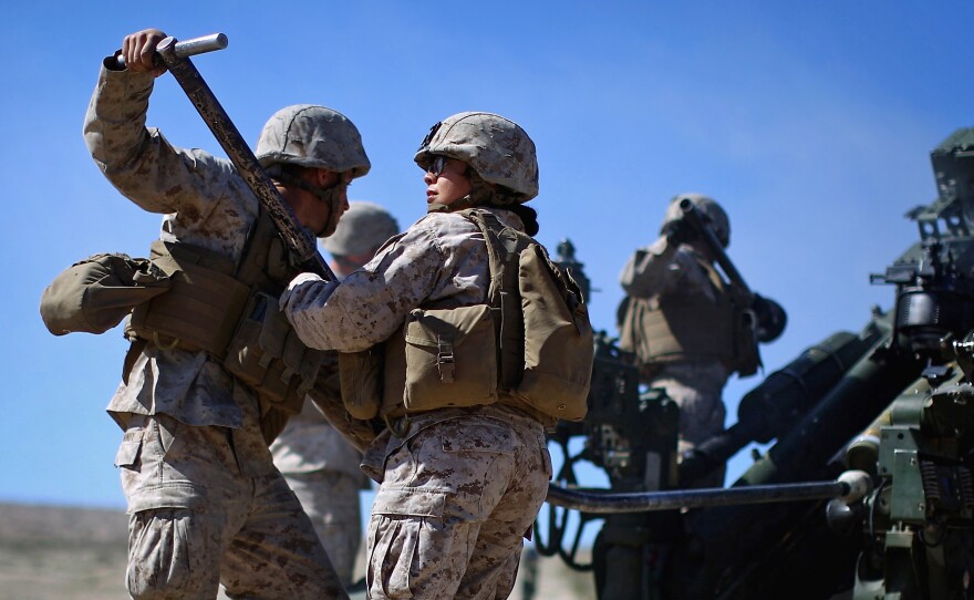 Pentagon chief Ash Carter is expected to announce that women can now serve in frontline combat posts. Here Carolina Ortiz moves away from a 155 mm artillery piece after loading it during a live-fire exercise at the Marine base in Twentynine Palms, Calif., earlier this year, in a a months-long study of how women might perform in ground combat jobs.