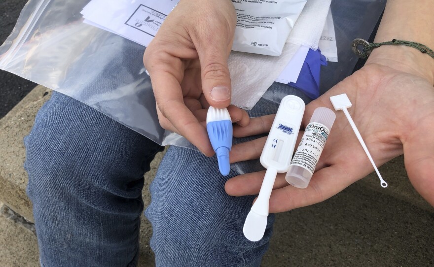 Brooke Parker displays an HIV testing kit in Charleston, W.Va. amid one of the nation's highest spikes of HIV cases.