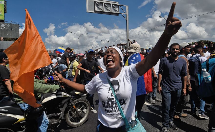 Opposition activists at the march in Caracas. Venezuela's economy is in freefall; inflation is rampant, lootings and riots are common, and blackouts are frequent.