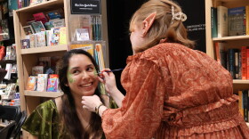 Dalia Luque, left, has her face painted by Amber Lovold, one of the organizers of a midnight release party at Politics and Prose in Washington, D.C. They are celebrating the publication of A Court of Splintered Harmony, the latest installment of Sarah J. Maas' popular romantasy series.