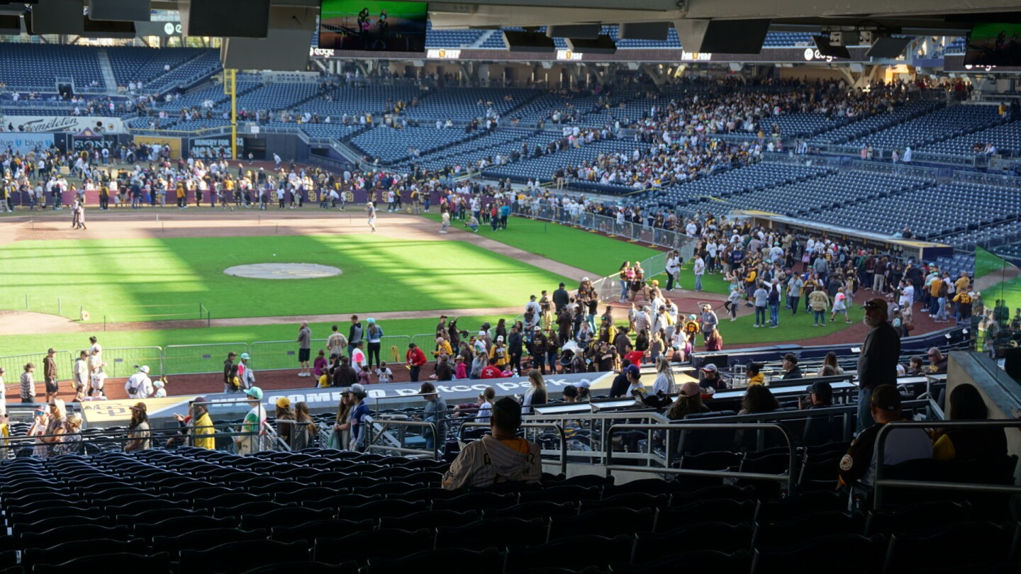 Fans walk onto the field at Petco Park during San Diego Padres Fanfest.
