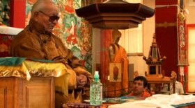 Chögyal Namkhai Norbu teaches while his son, Yeshi, looks on as Rinpoche gives teachings to thousands of local Kalmyks.