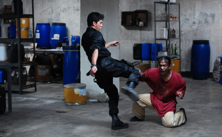 Iko Uwais as Rama and Acip Sumardi as another gang member in "The Raid."