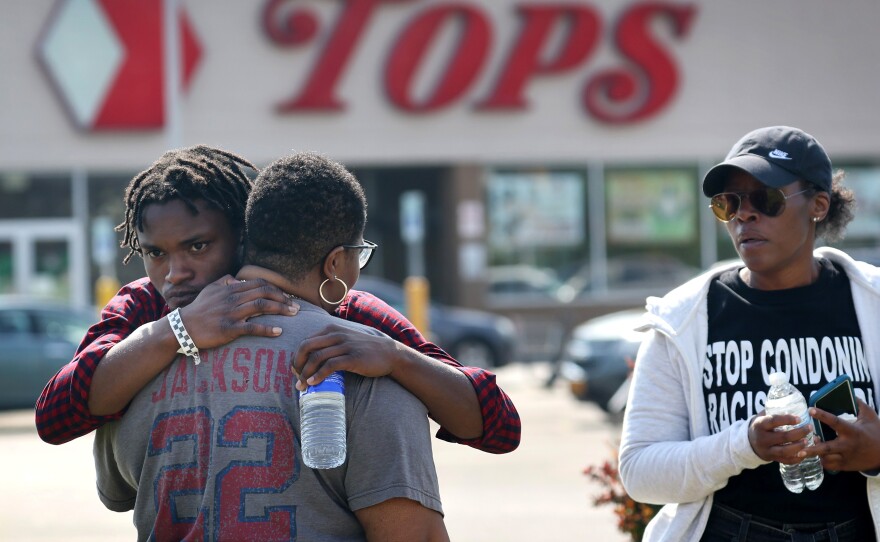 People gathered outside of Tops market embrace on Sunday.