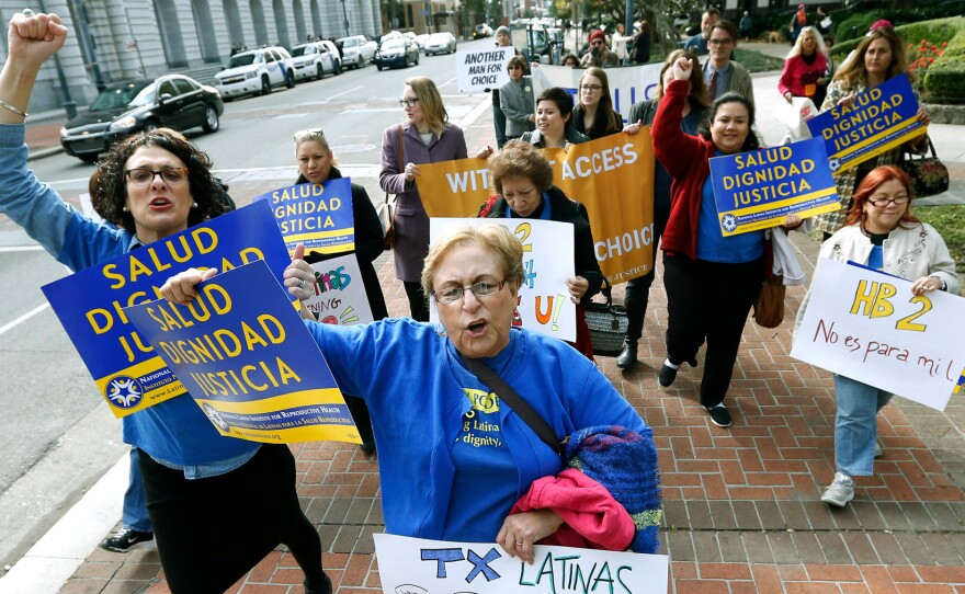 Women with the National Latina Institute for Reproductive Health demonstrate Wednesday outside the 5th U.S. Circuit Court of Appeals in New Orleans. A federal appeals court in New Orleans is considering whether a Texas law puts up an unconstitutional obstacle to women seeking abortions.